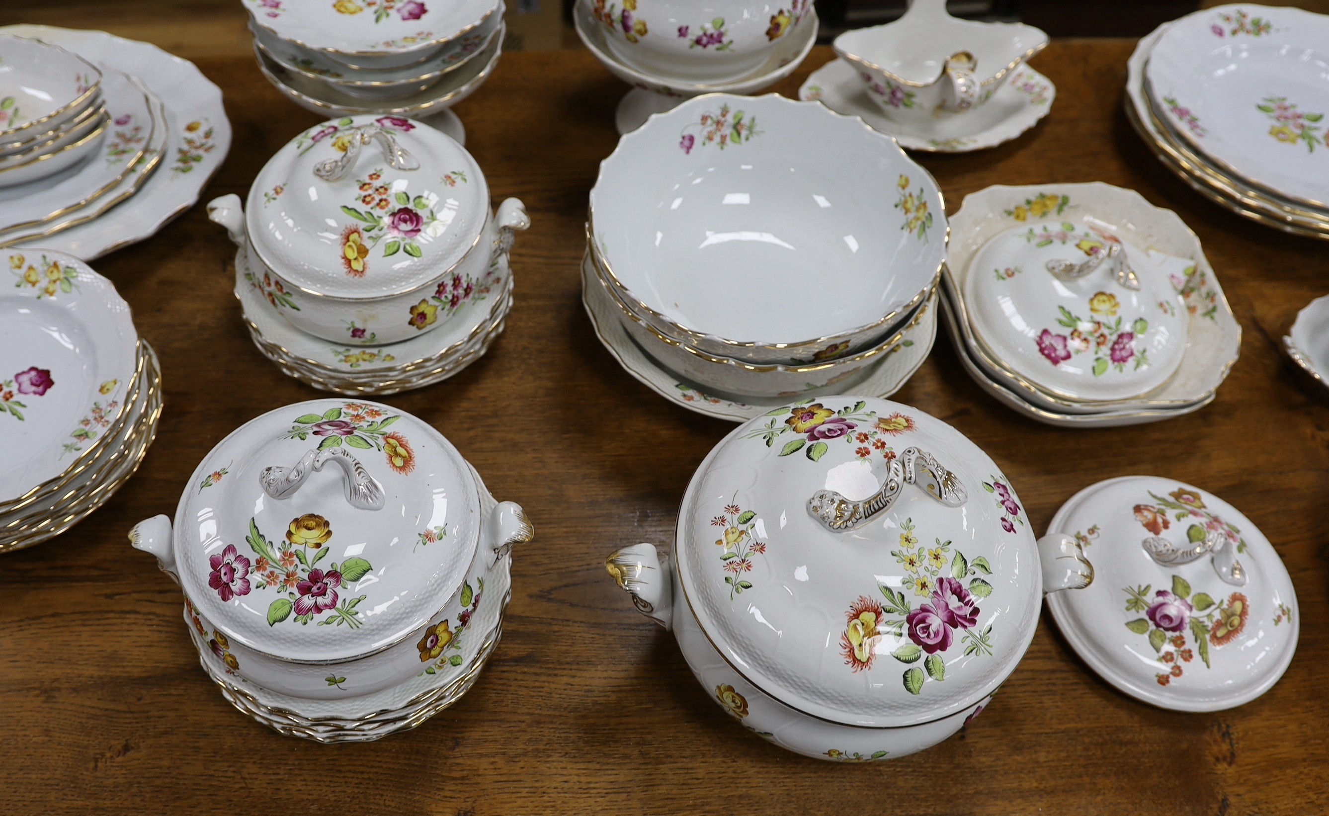 An extensive early 20th century Belgian floral painted earthenware dinner service